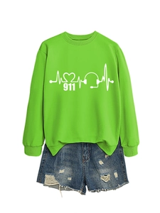 Flat lay of green sweatshirt with heartbeat print and ripped denim shorts for women