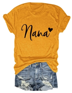 Flat lay of mustard yellow Nana heart t-shirt paired with ripped denim shorts