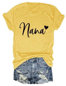 Flat lay of yellow Nana heart print T-shirt paired with distressed denim shorts
