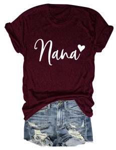 Detail of Nana heart print on deep red cotton T-shirt with ripped denim shorts