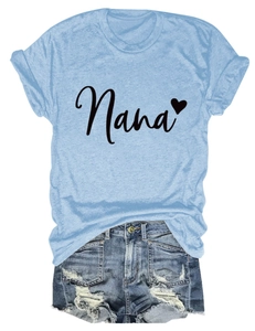 Detail of light blue Nana heart print t-shirt and distressed denim shorts on white backdrop