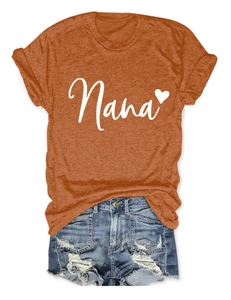 Detail of burnt orange Nana heart print T-shirt paired with ripped denim shorts