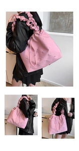 Close-up of pink pleated shoulder bag with sparkling rhinestones and ruffled strap