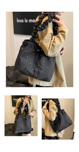 Detail of black pleated tote bag with sparkling rhinestones and comfortable shoulder strap
