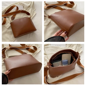 Macro view of retro brown PU leather shoulder bag showing interior capacity and wide strap