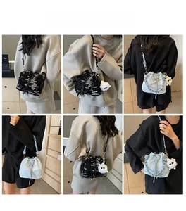 Detail shots of bucket bags in black and blue with woven straps and cute plush pendant