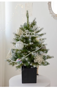 Close-up of a 60cm PE snow-covered Christmas tree with white ornaments in a black pot