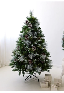 Close-up of frosted artificial Christmas tree with snow-tipped needles and pine cones