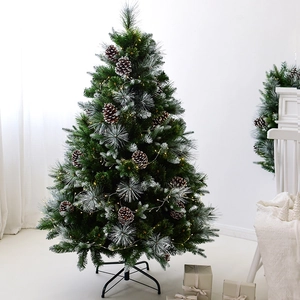 Frosted pine needle Christmas tree with warm LED lights and natural cones on metal stand