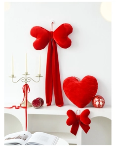 Detail of red velvet heart pillow and ribbon bows for Valentine's Day party decor