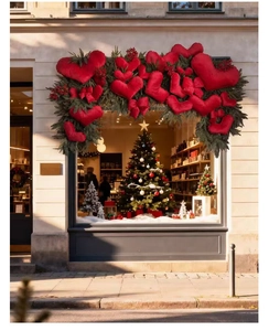 Large plush red heart decoration displayed in a festive storefront window display