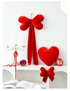 Detail of red velvet bow wall decor and heart pillow for romantic Valentine room setting