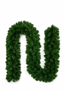 Detailed view of dense dark green PVC Christmas garland with realistic pine needle texture