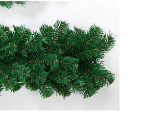 Close-up detail of dense green artificial pine needles for Christmas decoration
