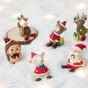 Miniature resin Christmas figurines featuring Santa and animals on snow for decor
