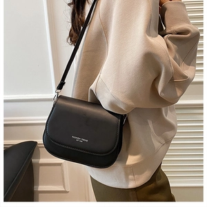 Close-up of black crossbody bag detail with Fashion Trend text and adjustable strap