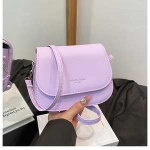 Close-up of light purple matte PU leather saddle bag with fashion trend typography