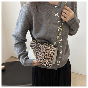 Detail of leopard print flap and gold chain strap on stylish chain crossbody bag