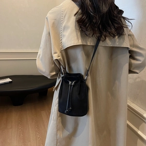 Minimalist black drawstring bucket bag with leather strap for women casual daily styling