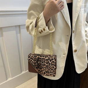 Chic leopard print flap shoulder bag with gold chain strap on stylish model
