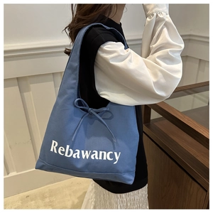 Blue canvas tote bag with Rebawancy letter print and decorative side drawstring bow