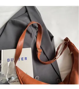 Brown moon tote bag detail featuring smooth adjustable shoulder strap and leather texture