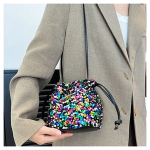 Detailed view of a sequin bucket bag with colorful sequins and a black drawstring closure