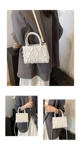 Detail of white canvas crossbody bag with elegant quilted fringe and top handle design