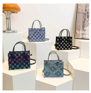 Detail of checkered denim tote bags featuring fringe edges and various stylish patterns
