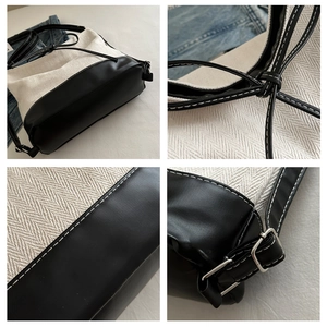 Close-up of black and white herringbone canvas tote with adjustable strap and drawstring