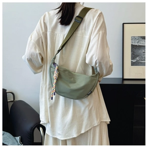 Detailed back view of a crescent moon crossbody bag in olive green nylon fabric