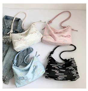 Detailed view of tote bags in four colors with floral embroidery and bow accents