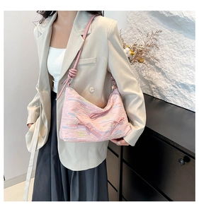 Detail of pink canvas hobo bag with wave embroidery and 3D bow on adjustable strap