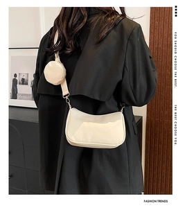 Detail of off-white crossbody bag set with wide shoulder strap and round coin pouch