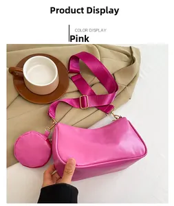 Pink semi-circle PU shoulder bag with purple nylon strap and matching mini coin purse