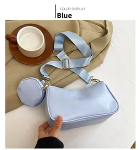 Detail of light blue crossbody bag with round coin purse and nylon wide strap