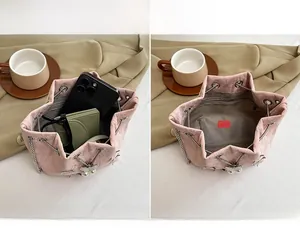 Pink drawstring bucket bag detail showing spacious interior with phone and wallet