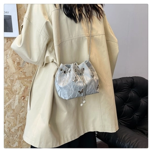 Silver bucket bag with 3D metal butterflies and drawstring pearl detail on chain strap