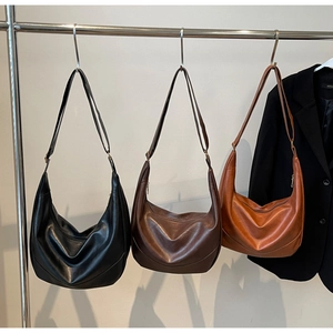 Detailed display of vintage pleated hobo bags in black, dark brown, and caramel colors