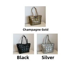 Three quilted down tote bags in champagne gold, black, and silver waterproof nylon