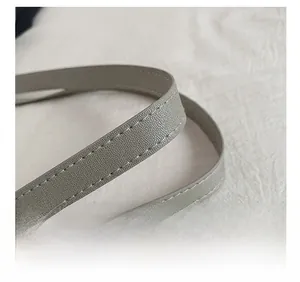 Close-up of durable faux leather tote strap with high-quality stitching and lychee grain texture