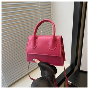 Close-up of small rose pink tote bag in smooth leather finish with sturdy top handle