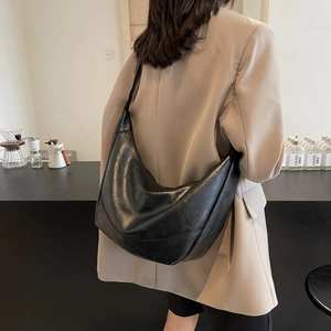 Minimalist black crescent shoulder bag in soft leather finish for women daily use