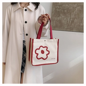 Detail of Korean canvas tote bag with red flower print and matching red handles