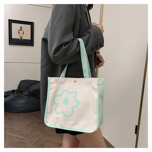 Detail of Korean style canvas tote bag with green flower print and top handles