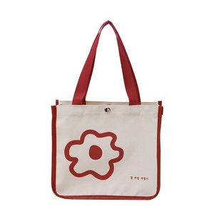 Minimalist canvas tote bag with red floral print and top handles for daily use
