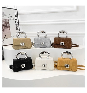 Detailed close-up of colorful mini handbags featuring pleated leather and fluid metal handles