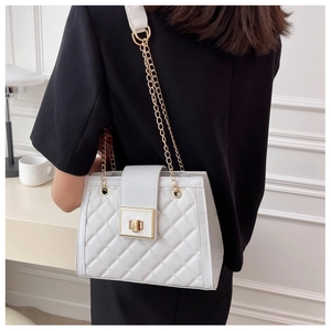 Detail of white quilted leather crossbody bag with golden chain and metallic lock closure