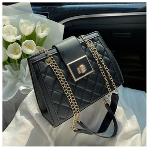 Close-up of a black quilted crossbody bag with gold twist lock and elegant tulips
