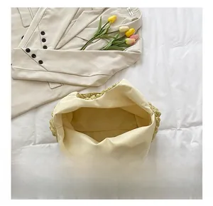 Detailed interior view of the yellow pleated bucket bag showing the spacious inner lining